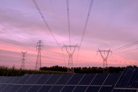 Solar panels, a clean energy concept, are built above the pondの写真素材