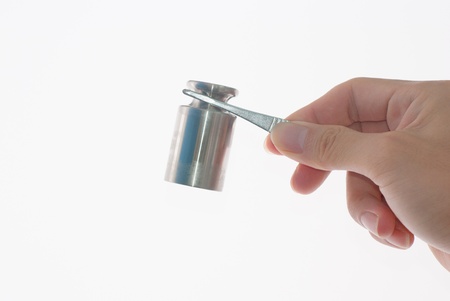 Calibration weights on tweezersの写真素材