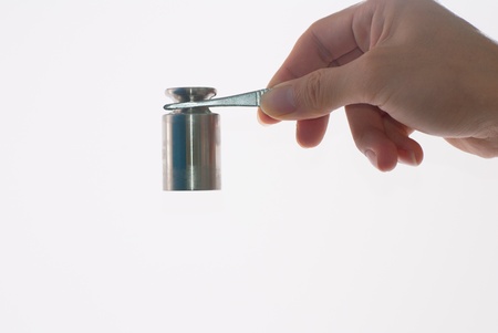 Calibration weights on tweezersの写真素材