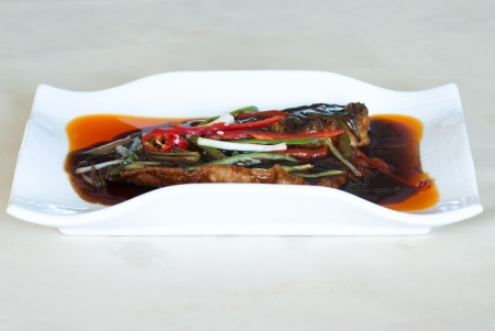 The roasted fillet of tilapia served with capsicumの写真素材