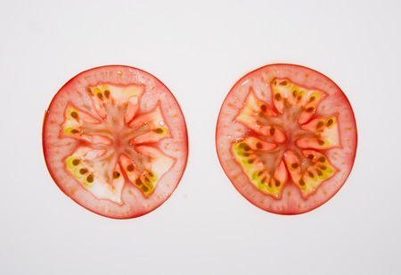 Some tomato slice isolated on white backgroundの写真素材