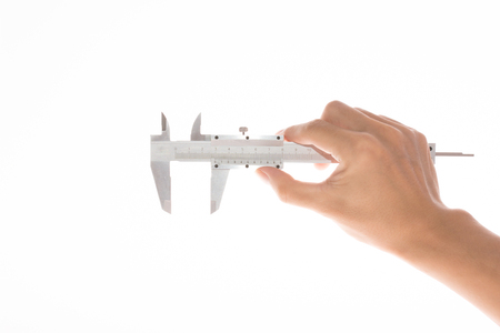 a hand have a caliper on white backgroundの写真素材