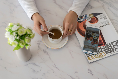 Hand holding a coffee cupのeditorial素材