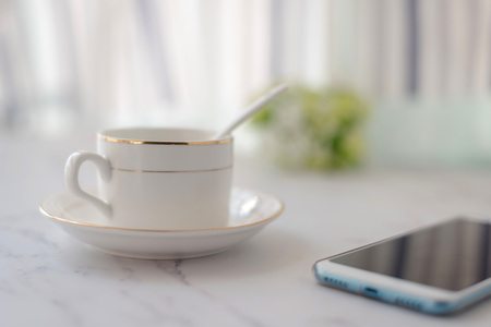 Coffee cup and mobile phoneの写真素材