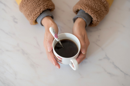 Hand holding a coffee cupの写真素材