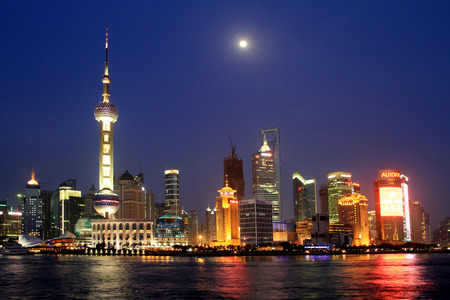 As night fell, the Shanghai Pudong New Area brilliantly illuminated. As the moon rises, and the Oriental Pearl Tower echo each other at a distance, showing the international metropolis Shanghai prosperityのeditorial素材