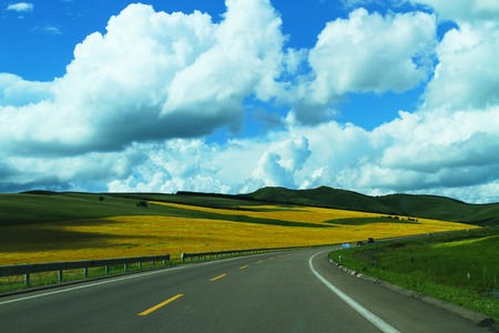 Grassland channel  In the blue sky and white clouds grass big channel, the vast grassland, and the sheep andMongolia sheep Chinese tiny spots, we in Inner Mongolia Hulun Buir Grassland channel flat wide driving, a beautiful picture from the eyes の写真素材