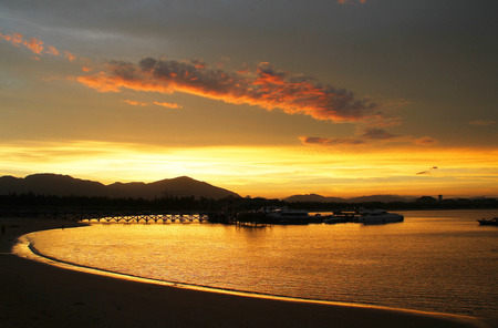 Golden bay  Golden Bay Sea, filled with Jin Bo  Sanya City, Hainan province Chinese Haitang Bay, the beautiful sunset red Begonia Sanya bay  Blue sea, blue sky, silver sand, oasis, showing a picture of a beautiful landscape painting の写真素材