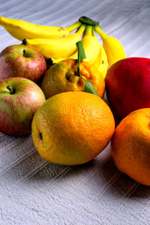 Tropical fruit mix on a table with white tablecloth.の写真素材