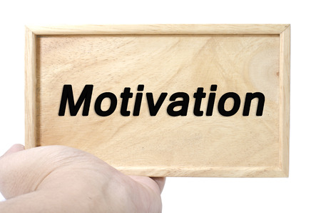 Business and motivation concept. hand holding plain wood with word motivationの写真素材