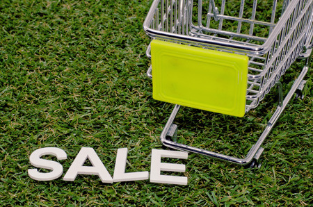 image concept cropped trolley with word sale on artificial grassの写真素材