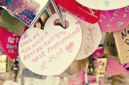 image concept a keychain with love shape with loving caption, retro and vantage look.blur and grain backgroundの写真素材