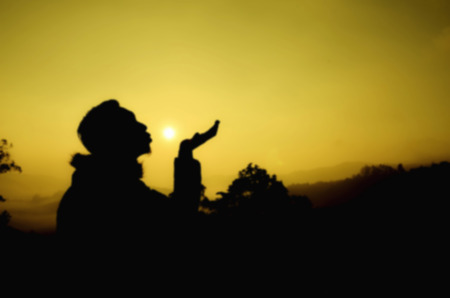 blur and creative silhouette man during sunset sunrise giving a kissの写真素材