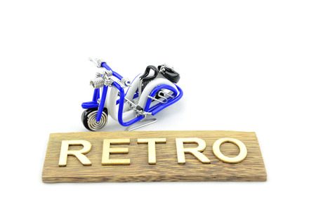 handcraft scooter made from blue and white wire with word retro made from wood on dark brown wood plateの写真素材
