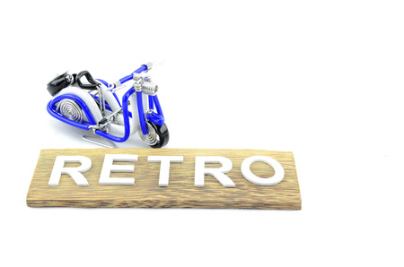 beautiful handcraft scooter placed top left with word retro in white color made from woodの写真素材