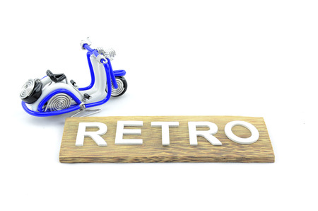 handcraft scooter on top left with plain wood. retro word made from white wood isolated white backgroundの写真素材
