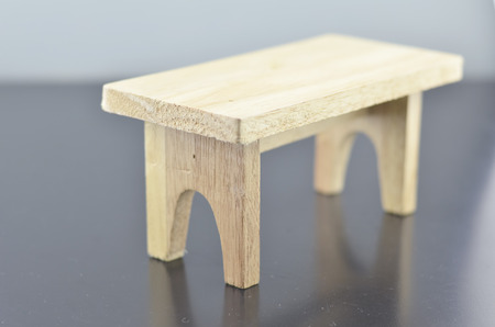 retro and soft look image of wooden table with reflection on dark  floor
