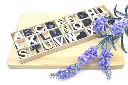 alphabetical collection with artificial lavender isolated white backgroundの写真素材
