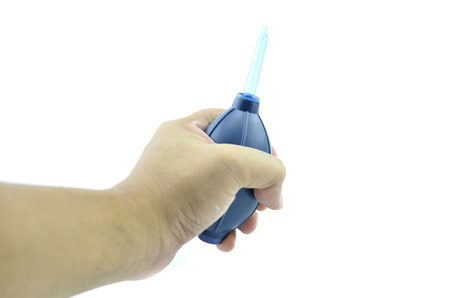 hand hold up blue air blower isolated white backgroundの写真素材