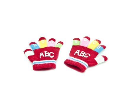 a pair red survenir children hand glove isolated white backgroundの写真素材