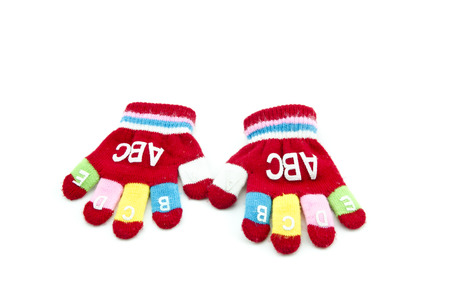 two red survenir children hand glove isolated white backgroundの写真素材