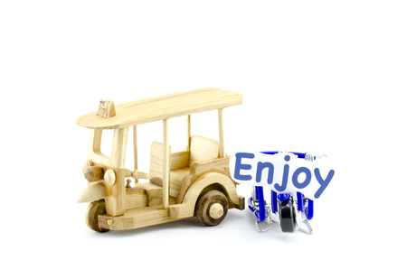 handcrafted tuk-tuk  made from wood and scooter made from wire  with word enjoy isolated white backgroundの写真素材