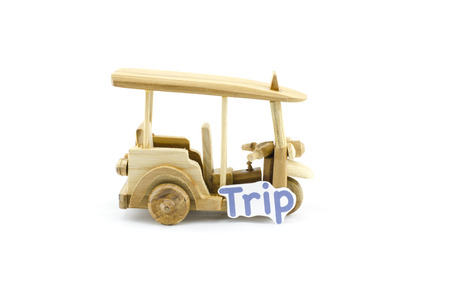 handcrafted souvenir.thailand iconic transport,tuk-tuk  made from wood with word trip isolated white backgroundの写真素材