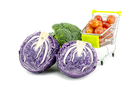 fresh raw purple cabbage, cherry tomatoes on trolley and broccoli  isolated white backgroundの写真素材
