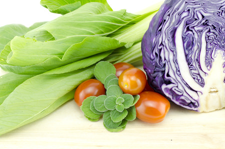 assorted vegetable ingredient on wooden cutting board isolated white backgroundの写真素材