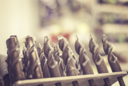 blurred image of different type of metal steel heads and bits with retro color mode.