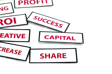 business motivation word CAPITAL, SUCCESS, and SHARE  printed on paper with red color isolated on white backgroundの写真素材
