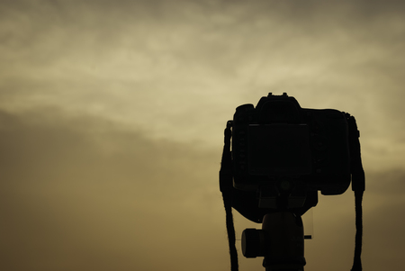 silhouette image of digital camera on tripod during sunsetの写真素材