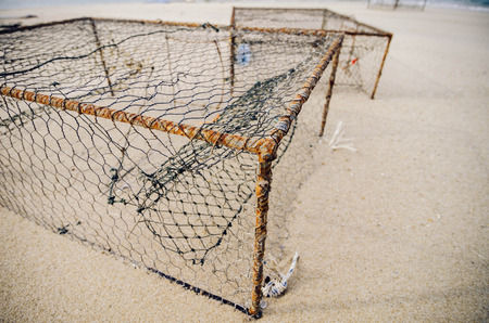 closeup rusty crab pots on the sandy beach.focus in the middle.shallow depth of field.color toning effectの写真素材