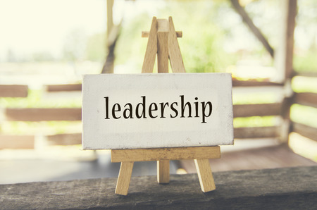 Business marketing concept, word LEADERSHIP on white canvas and wooden easel over blurred background at sunny day.の写真素材