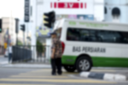 blurred image background, pedestrian crossing the road at sunny day.の写真素材