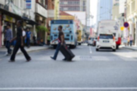 blurred image background, group of pedestrian crossing the road at sunny day.の写真素材