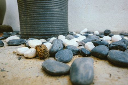 black and white stones over ceramic pot at garage.selective focus shot with color effectの写真素材