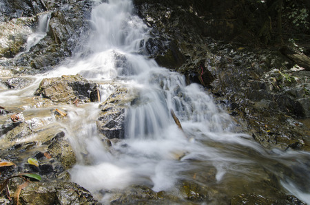 beautiful nature,cascaded  tropical river flowing through over wet rock at sunny day