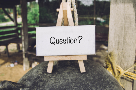 image concept, word QUESTION on white canvas and wooden easel over blurred backgroundの写真素材