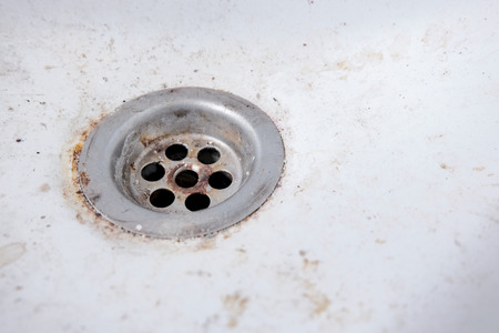 dirty and rusty wash basin drain outletの写真素材