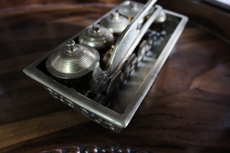 Malay heritage brassware, wedding equipment called Tepak Sireh over wooden background. shoot in low light and selective focusの写真素材