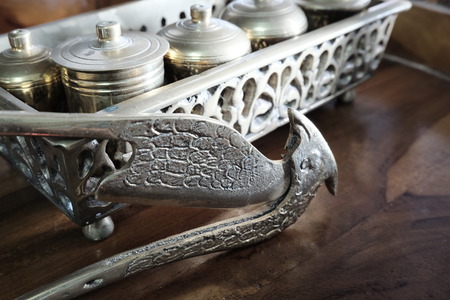 Malay heritage brassware, wedding equipment called Tepak Sireh over wooden background. shoot in low light and selective focusの写真素材