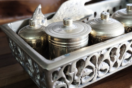 Malay heritage brassware, wedding equipment called Tepak Sireh over wooden background. shoot in low light and selective focusの写真素材