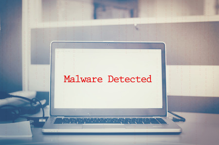 Red word, malware detected display on laptop screen. cyber attack and threats conceptの写真素材