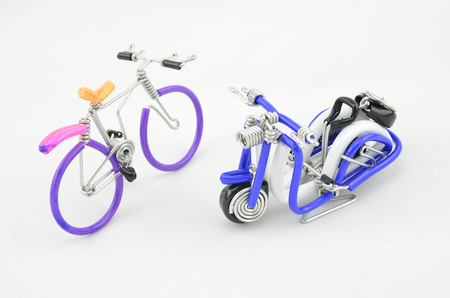 handcrafted souvenir, scooter and bicycle made from colorful wire isolated on white background.selective focus shotの写真素材