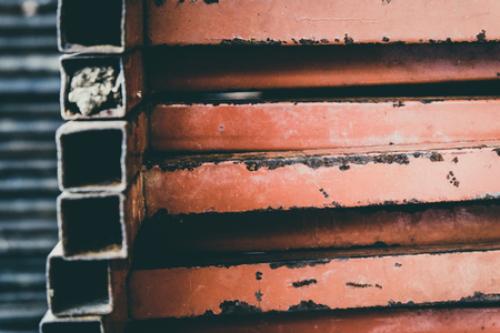 closed up stacks of rusty stainless table stands background.faded effect and selective focusの写真素材