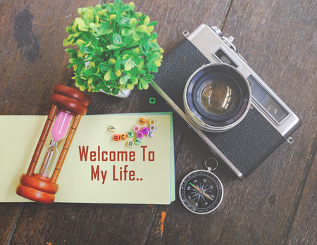 word WELCOME TO MY LIFE on note pad with decorative item background for enjoyment and celebration conceptの写真素材