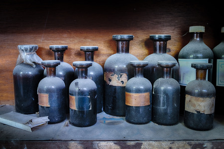 vintage image of still life composition,glass chemical bottle on wooden rack.selective focus shotの写真素材