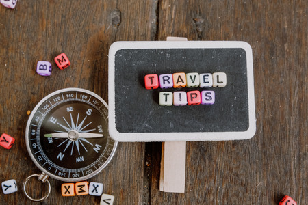 TRAVEL TIP word block on wooden signage with compass conceptの写真素材