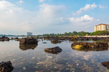 Beautiful nature, tropical beach with clear water and stones. reflection and cloudy blue sky backgroundの写真素材